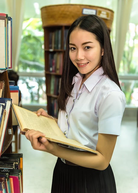 students studying library campus books laptops